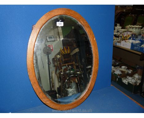 An oval Mirror with wooden surround