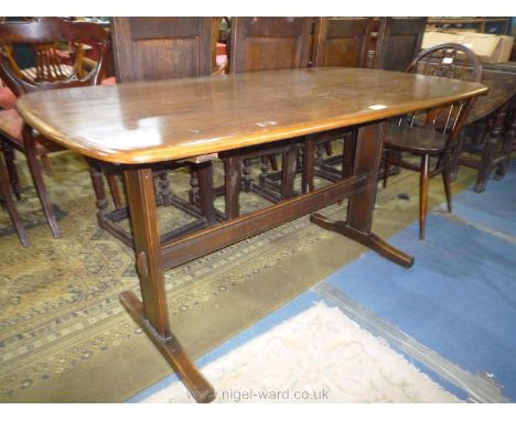 An Ercol Dining Table on two supports with central stretcher, 54'' x 29 1/2'' x 28'' high