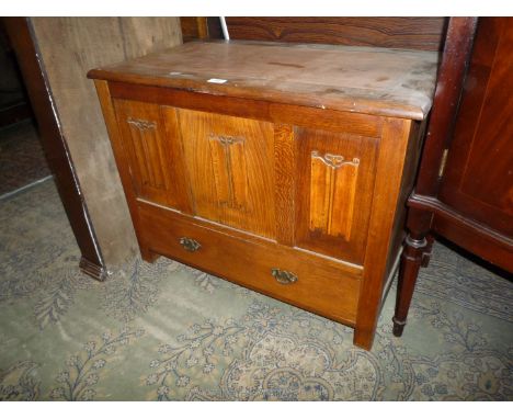 A mixed woods Blanket Box/Trunk having three linen fold panel details and lower drawer