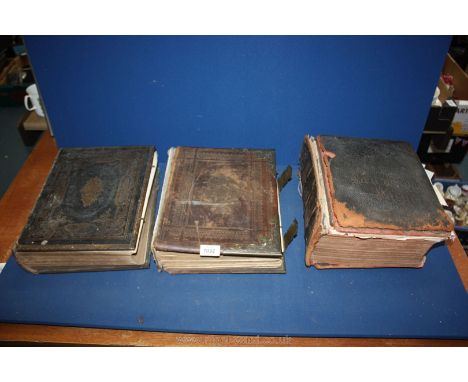 Three antique Bibles, leather bound with brass fixings, one with Welsh with colour plates, Swedish and English Old and New Te