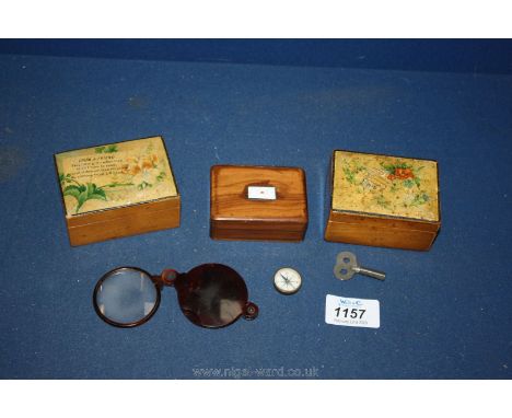 Three small boxes, a compass and a folding eye glass.