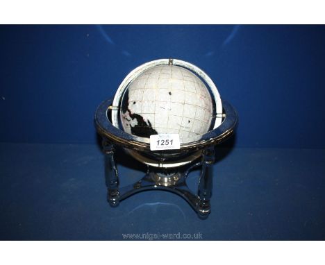 An Osbourne &amp; Allen rotating gemstone/mother of pearl Globe with compass. (globe 6'' diameter)