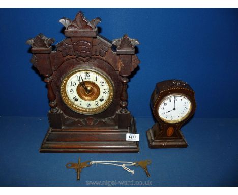 An ornate wooden cased Mantle clock with Arabic numerals on a white face, with two keys and pendulum together with a smaller 