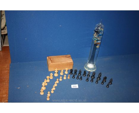 A box of wooden Chess pieces and a Galileo thermometer