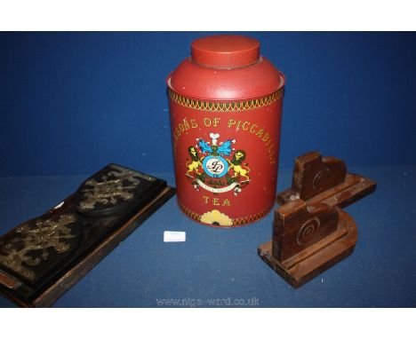 A red metal 'Jacksons of Piccadilly' tea caddy, small wooden bookshelf (broken) and wooden bookends