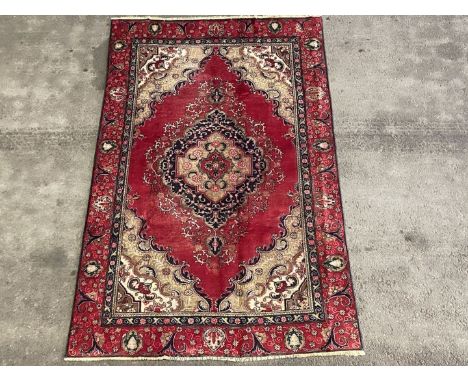 A vintage red hand-made Mahal Rug, 270 by 169cm.