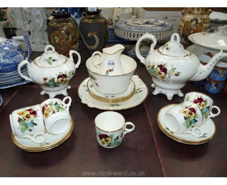 A pansy decorated part Victorian Teaset including large teapot, milk jug, cake plate, six saucers, five cups, four tea plates