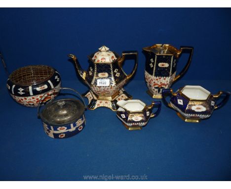 An Imari style, teapot and stand, hot water jug, milk jug and sucrier, a rose bowl and a lidded pot and lid.