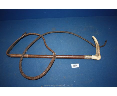 A leather whip with antler handle and silver collar, steel lined.