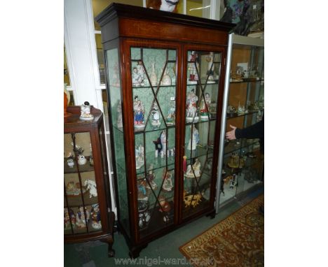 An Edwardian Mahogany china Display Cabinet having crossbanded and light and darkwood stringing, 13 pane glazed doors and sta