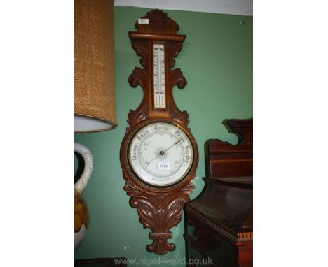 A banjo style Aneroid Barometer/thermometer in decorative wooden casing.