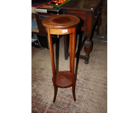 An Edwardian Mahogany circular jardiniere Stand with lower shelf, 36'' high, 12 1/4'' diameter