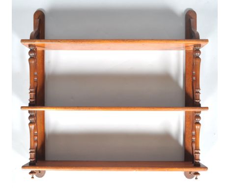 A 19th century mahogany hanging three tier wall shelf with tapered uprights, 76cm high x 76cm wide x 16cm deep