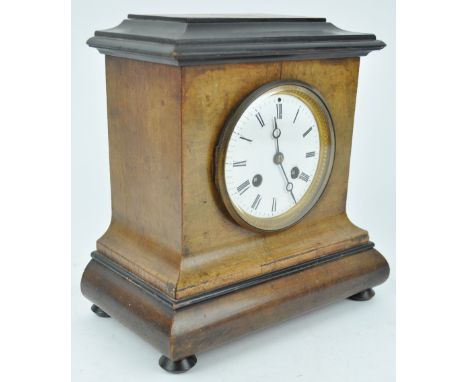 A late 19th century mantle clock, the enamel dial in walnut and ebonised case, the movement stamped Brevete 1514, with wheel 