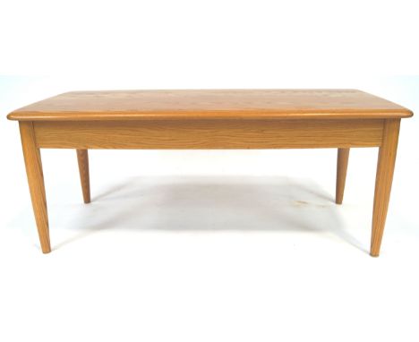 An Ercol elm wood coffee table with shaped rectangular top on plain legs, 40cm high x 102cm wide x 52cm deep