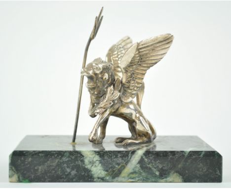 A green stone paperweight, set with a white metal lion of St Mark, wearing a laurel victor's wreath, sat by a trident, 13cm h