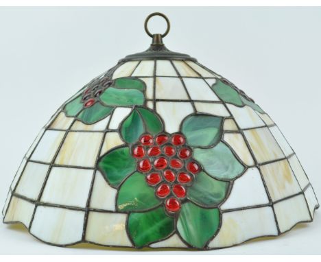 A large Tiffany style pendant light shade, decorated with bunches of grapes in foliage, 28cm high x 43cm wide