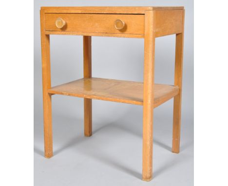 A 1950's golden oak side table with single drawer with knob handles to top and lower shelf tier beneath, all raised on square