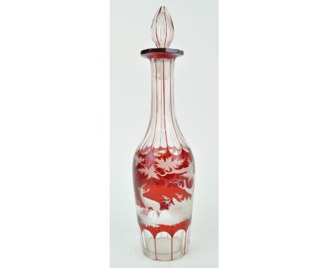 A Victorian Bohemian ruby flash glass and wheel engraved decanter and stopper, decorated with a stag and deer in a landscape,