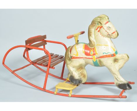 A 1950's retro vintage children's Mobo rocking horse. The horse having a tinplate construction with wooden slatted seat behin