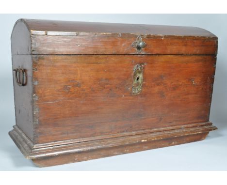 A 19th century Continental domed trunk, later stained, with two wrought iron handles on a moulded plinth base, 79cm high x 12