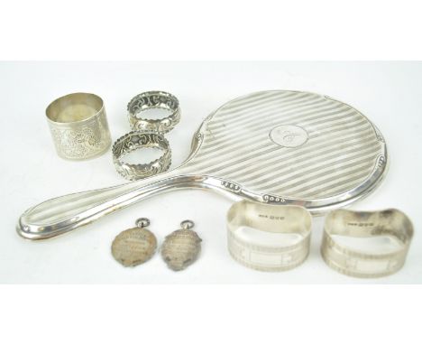 A silver hand mirror, of round form with bands of engine turned decoration, Birmingham 1922, 26cm high, together with a group