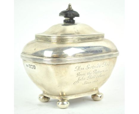  A silver tea caddy, of rounded rectangular form with domed hinged cover, raised on ball feet, by Garrard &amp; Co Ltd, Londo