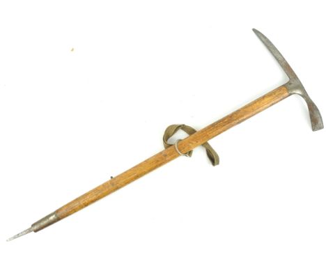 A WWII Second World War period Stubai Austrian ice axe having a steel axe head, wooden handle, canvas strap and steel point t