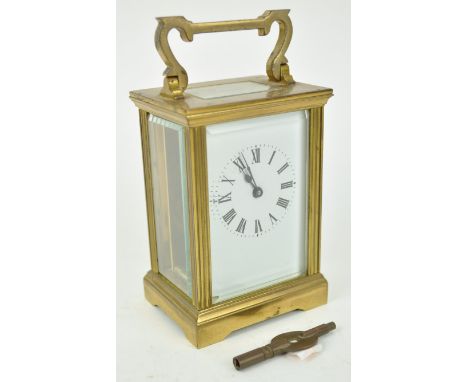 A brass carriage clock with rectangular enamel dial, overall 14.5cm high x 8cm wide x 6cm deep
