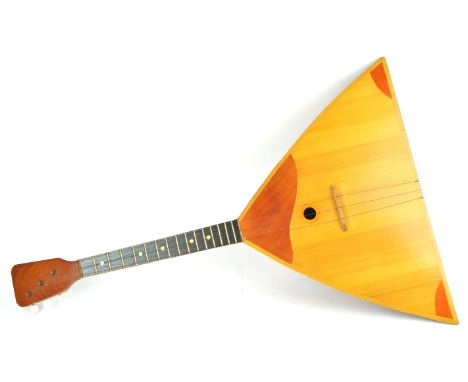 An inlaid wood Balalaika with typical domed back and three strings, 69cm long