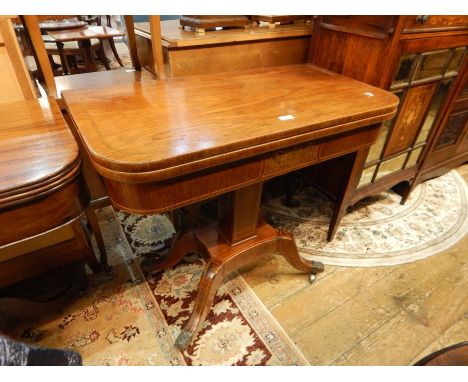 Regency brass inlaid rosewood foldover swivel top card table, having curved corners, brass line inlays to the top, the frieze