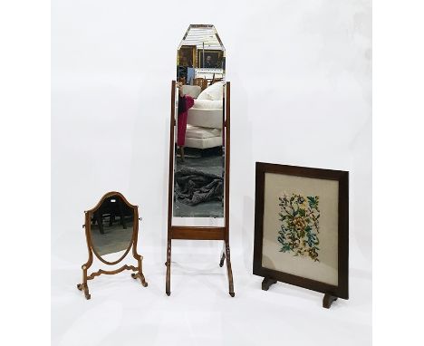 Oak framed firescreen with floral needlework panel, a Hepplewhite style shield-shaped dressing table mirror and a cheval mirr