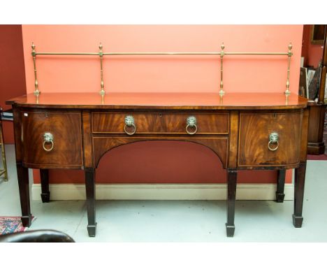 A MAHOGANY BOW-FRONTED SIDEBOARD, early 19th century, with brass rail and centre frieze drawer, flanked to each side with two