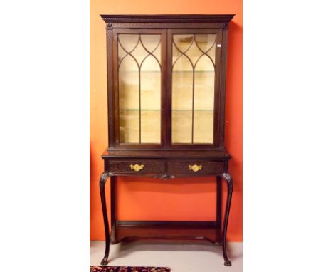 A MAHOGANY CHIPPENDALE STYLE DISPLAY CABINET, with dentil-moulded cornice, above a blind fret frieze and two Gothic glazed do