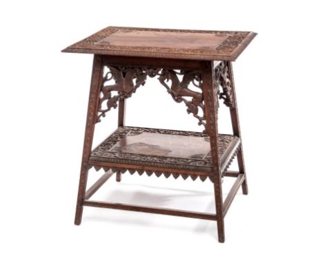 AN UNUSUAL TWO-TIER CARVED HARDWOOD OCCASIONAL TABLE, probably Indian, the top with a centre panel with fan spandrels and a b