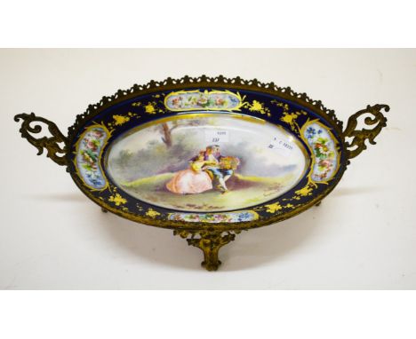 AN OVAL SEVRES STYLE FRENCH PORCELAIN TABLE CENTRE, in gilt brass frame with scrolling handles and pierced gallery, the oval 