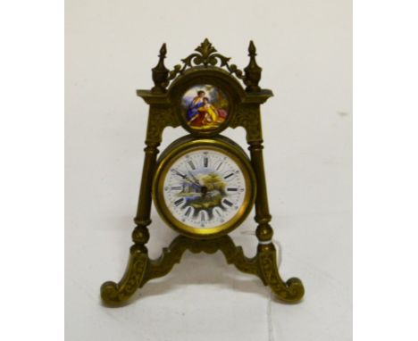 AN UNUSUAL EASEL-SHAPED DESK TIMEPIECE, the arched top with a centre enamel porcelain panel, depicting couple in landscape, a