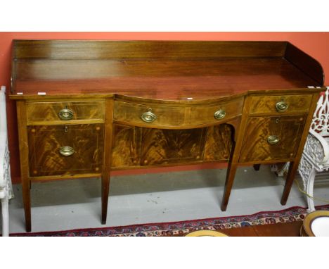 A GEORGE III PERIOD MAHOGANY BOW-FRONTED INLAID SIDEBOARD, with three-quarter gallery, above an arrangement of three frieze d