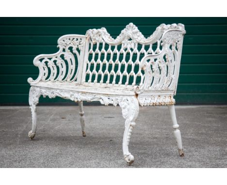 A PAIR OF HEAVY WHITE PAINTED CAST IRON GARDEN BENCHES, each shaped and floral cast back with a panel of horse-shoe designs, 