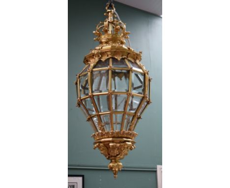 A VERY ATTRACTIVE TWELVE-SIDED GILT BRASS POT BELLY HALL LANTERN, with forty-eight bevelled and glazed panels, and a leaf cas