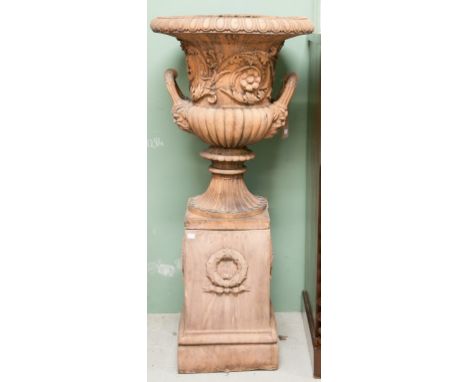 AN ATTRACTIVE PAIR OF TERRACOTTA STYLE CAMPANA-SHAPED MOULDED GARDEN URNS, each with two double-mask handles and half-reeded 