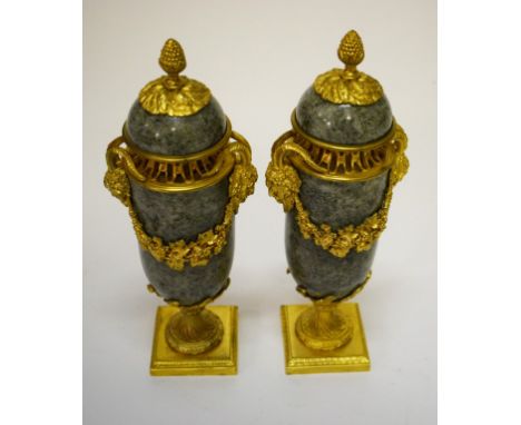 A PAIR OF GREEN MARBLE AND GILT BRASS MOUNTED MANTEL PIECE URN AND COVERS, in the style of Matthew Bolton, with pineapple fin
