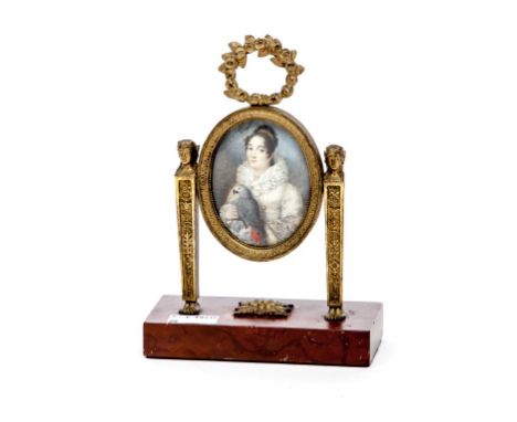 AN OVAL MINIATURE PORTRAIT, depicting lady holding a parrot, with rose wreathe crest, in oval frame, standing on empire style