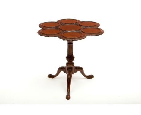 A CHIPPENDALE STYLE MAHOGANY SUPPER TABLE, with seven section dished top, the edge carved with ribbons and flower heads, the 