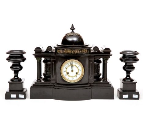 A BLACK POLISHED LIMESTONE AND BRASS-MOUNTED MANTEL CLOCK GARNITURE, of architectural design, the clock with a domed top and 