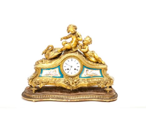 A VERY ATTRACTIVE FRENCH GILT BRASS MANTEL CLOCK, the arched top with two cherubs and a swan, above a circular enamel dial wi