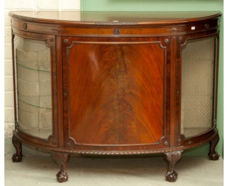 A BOW-FRONTED MAHOGANY DEMI-LUNE SIDE CABINET, in the Chippendale style, the moulded top above a bow-fronted door, flanked to