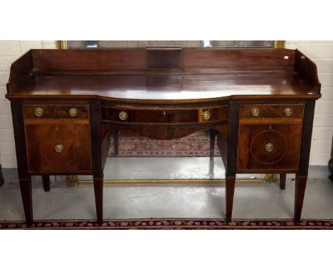 A 19TH CENTURY INLAID MAHOGANY SIDEBOARD, probably Irish, the three-quarter gallery above a bow front, with centre frieze dra