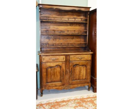 A FRENCH WALNUT DRESSER O,R.M., the moulded cornice above three railed plate racks, on a base with two frieze drawers and two