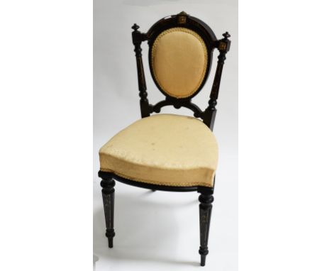 AN ATTRACTIVE SET OF FOUR LATE 19TH CENTURY EBONISED AND PARCEL GILT SIDE CHAIRS, each with oval padded back, above a bow fro